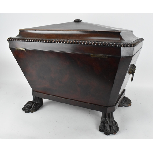 130 - A Regency style sarcophagus shaped mahogany cellerette, with gadrooned hinged top opening tin liner ... 