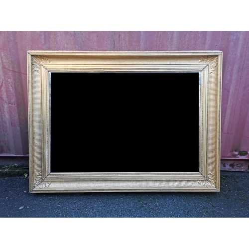 195 - A 19th century French gilt-wood and gesso mirror, with rectangular beveled plate in a moulded frame ... 