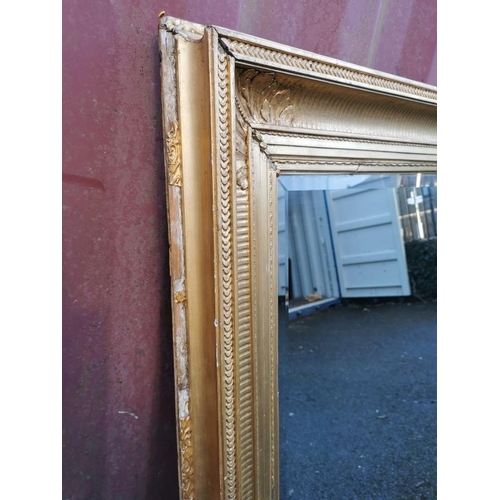 195 - A 19th century French gilt-wood and gesso mirror, with rectangular beveled plate in a moulded frame ... 