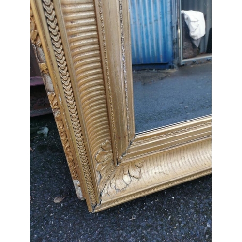 195 - A 19th century French gilt-wood and gesso mirror, with rectangular beveled plate in a moulded frame ... 
