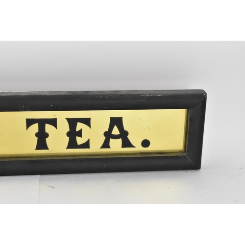 267 - A vintage glazed advertising sign for 'Eastmans pure tea',  with black lettering on gilt ground, in ... 