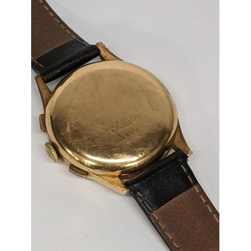 85 - A mid 20th century 18ct gold, chronograph manual wind, gents wristwatch, having a silvered dial with... 