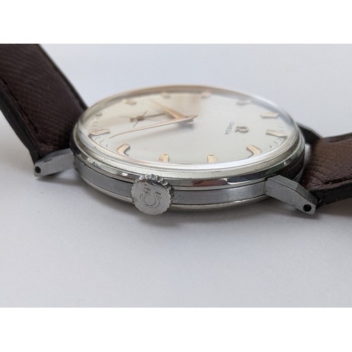 89 - A Omega manual wind gents wristwatch, circa 1958, having a white enamel dial with gilt applied hour ... 