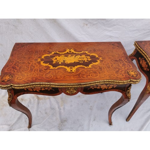 112 - A pair of 20th century walnut and marquetry card tables, the folded tops with eared corners mounted ... 