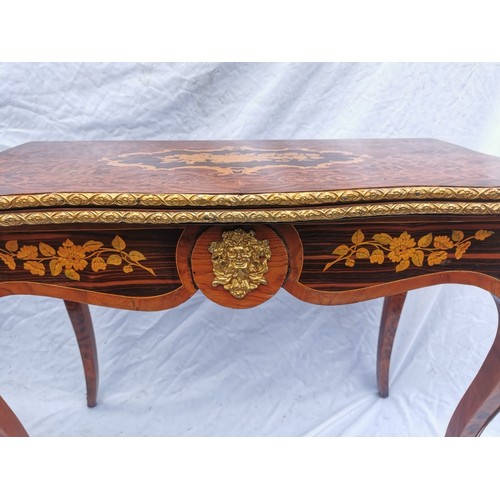 112 - A pair of 20th century walnut and marquetry card tables, the folded tops with eared corners mounted ... 