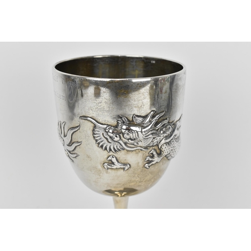 13 - An Edwardian Chinese export silver golf trophy cup by Wang Hing & Co, the body with embossed three-c... 