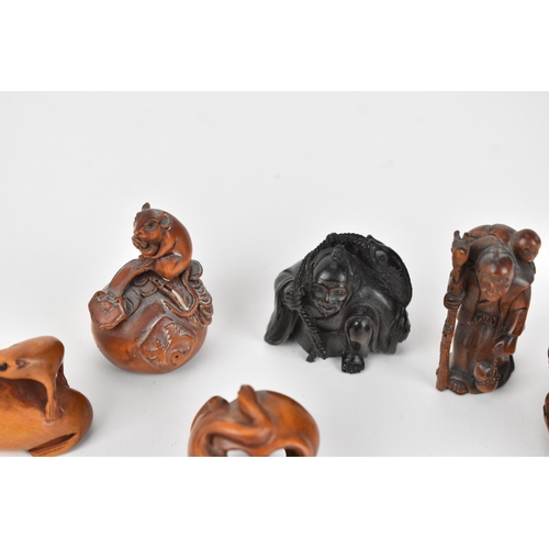 29 - A collection of seven 20th century Japanese wooden netsukes, comprising figural ones and animal ones