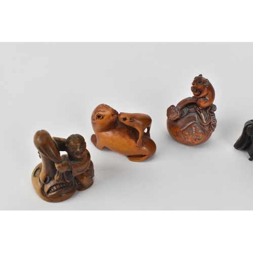 29 - A collection of seven 20th century Japanese wooden netsukes, comprising figural ones and animal ones