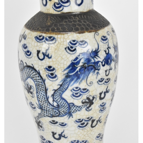 34 - A 19th century Chinese blue and white lidded baluster vase, with crackled glaze and bronze effect ba... 