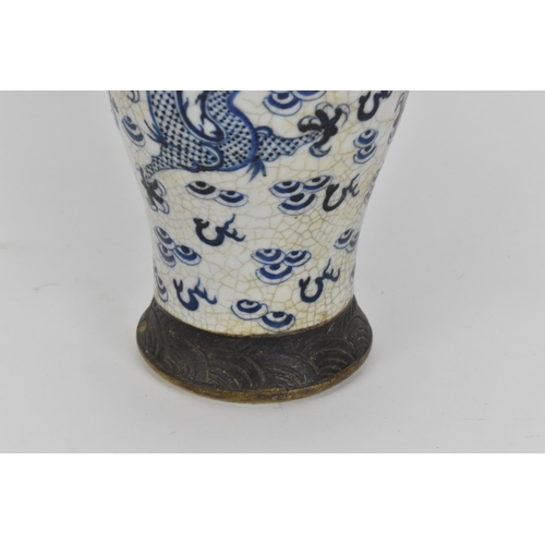 34 - A 19th century Chinese blue and white lidded baluster vase, with crackled glaze and bronze effect ba... 