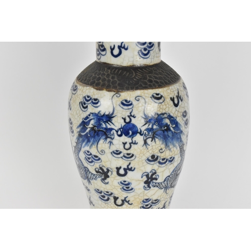 34 - A 19th century Chinese blue and white lidded baluster vase, with crackled glaze and bronze effect ba... 