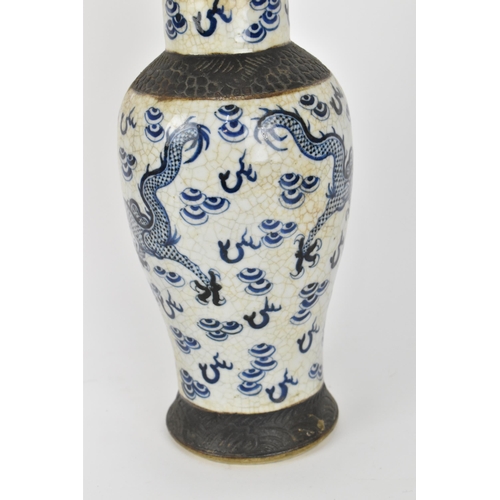 34 - A 19th century Chinese blue and white lidded baluster vase, with crackled glaze and bronze effect ba... 