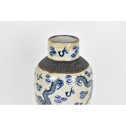 34 - A 19th century Chinese blue and white lidded baluster vase, with crackled glaze and bronze effect ba... 