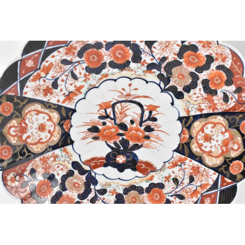 38 - A pair of Japanese Meiji period kinrande chargers, in the imari palette, with petal rim, centered wi... 