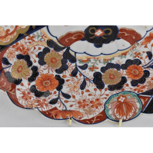 38 - A pair of Japanese Meiji period kinrande chargers, in the imari palette, with petal rim, centered wi... 