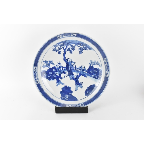 49 - A Chinese Qing dynasty blue and white charger, in the Kangxi style but 19th century, with central fi... 