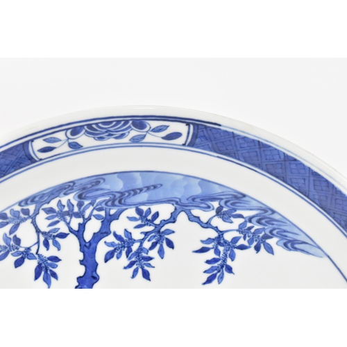 49 - A Chinese Qing dynasty blue and white charger, in the Kangxi style but 19th century, with central fi... 