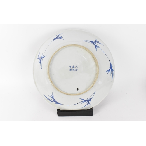 49 - A Chinese Qing dynasty blue and white charger, in the Kangxi style but 19th century, with central fi... 