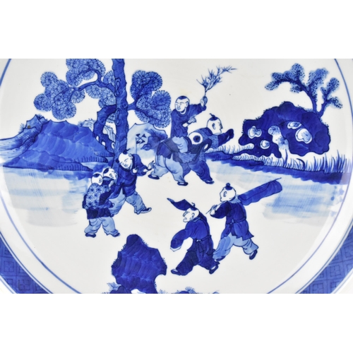 50 - A Chinese Qing dynasty blue and white charger, in the Kangxi style but 19th century, with central fi... 