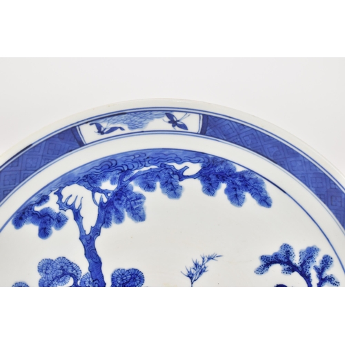 50 - A Chinese Qing dynasty blue and white charger, in the Kangxi style but 19th century, with central fi... 