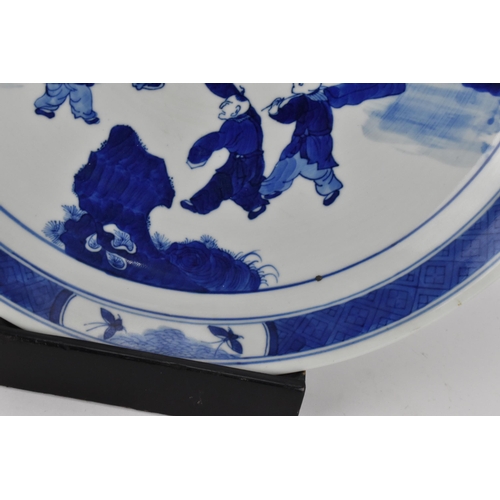 50 - A Chinese Qing dynasty blue and white charger, in the Kangxi style but 19th century, with central fi... 