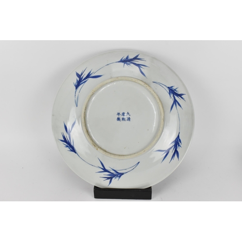 50 - A Chinese Qing dynasty blue and white charger, in the Kangxi style but 19th century, with central fi... 