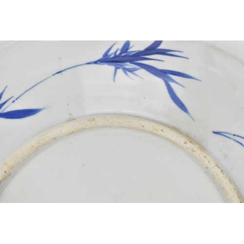 50 - A Chinese Qing dynasty blue and white charger, in the Kangxi style but 19th century, with central fi... 