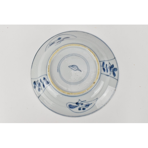 51 - A small Chinese Kangxi period blue and white dish, of circular form with foliate motif, the undersid... 