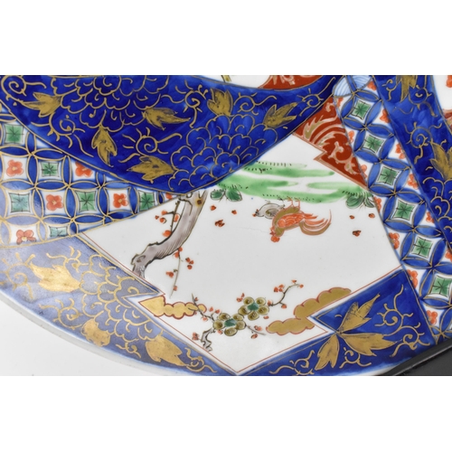 57 - Two Japanese arita porcelain chargers, late Meiji period, with enamelled outdoor vignettes with gilt... 