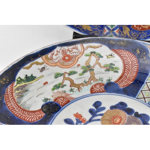 57 - Two Japanese arita porcelain chargers, late Meiji period, with enamelled outdoor vignettes with gilt... 