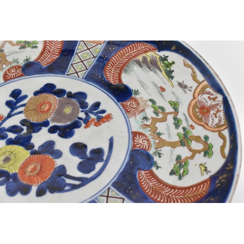 57 - Two Japanese arita porcelain chargers, late Meiji period, with enamelled outdoor vignettes with gilt... 