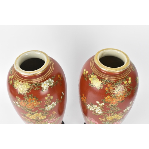 63 - A pair of Japanese Taisho period vases, possibly Satsuma, painted with floral blooms with fine gilt ... 