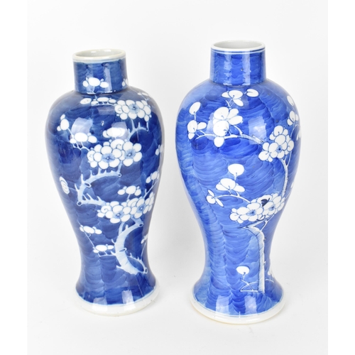 64 - Two Chinese blue and white prunus vases, of baluster form with branches of blooming prunus on a blue... 