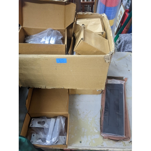 106 - A box of brass door handles with back plates, some with lock others missing, latches and a letter bo... 