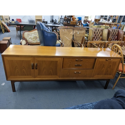 11 - A mid 20th century retro G-Plan teak sideboard having two cupboard doors, three drawers and a pull-d... 