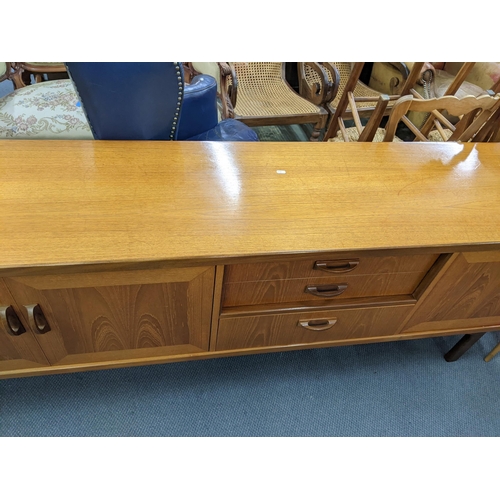 11 - A mid 20th century retro G-Plan teak sideboard having two cupboard doors, three drawers and a pull-d... 