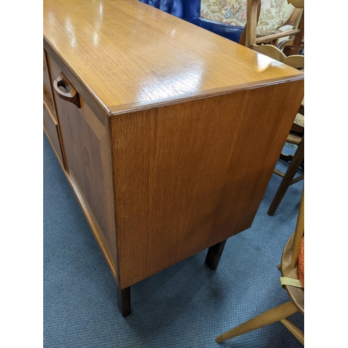 11 - A mid 20th century retro G-Plan teak sideboard having two cupboard doors, three drawers and a pull-d... 