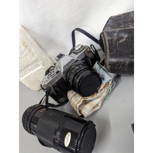 176 - A Canon AVI with case, (35mm) along with 2 telephoto lenses, two converters and a flash gun
Location... 