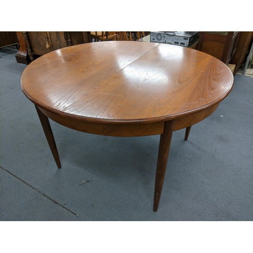 18 - A mid 20th century retro G-Plan teak Fresco extending dining table designed by Victor Wilkins, 73.5h... 