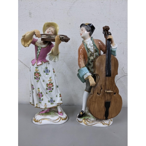 29 - Two 19th century continental porcelain figures of a lady playing the violin and man playing the cell... 