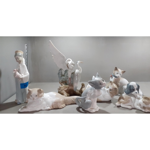 69 - A group of five Nao models of cats, dogs and herons together with two Lladro models of a young boy w... 