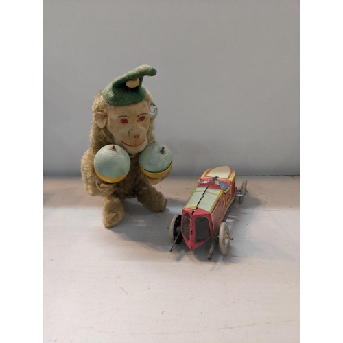 76 - A Carl Western Germany vintage wind-up monkey together with tin wind up car
Location:6.3