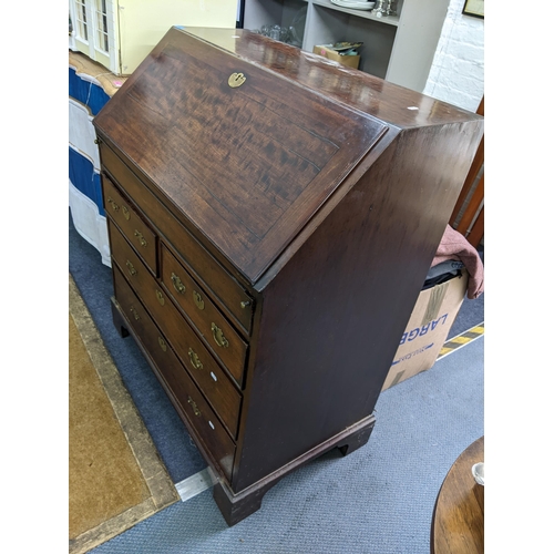 8 - A Georgian mahogany bureau having a fall flap opening to reveal pigeonholes and drawers, all above t... 