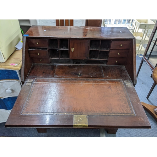 8 - A Georgian mahogany bureau having a fall flap opening to reveal pigeonholes and drawers, all above t... 