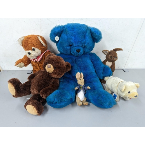 96 - A group of soft toys to include a large vintage Russ blue teddy bear, a D.A.Toys example, Peter Rabb... 