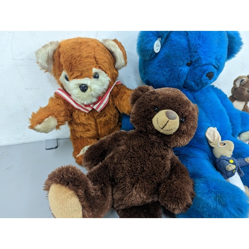 96 - A group of soft toys to include a large vintage Russ blue teddy bear, a D.A.Toys example, Peter Rabb... 