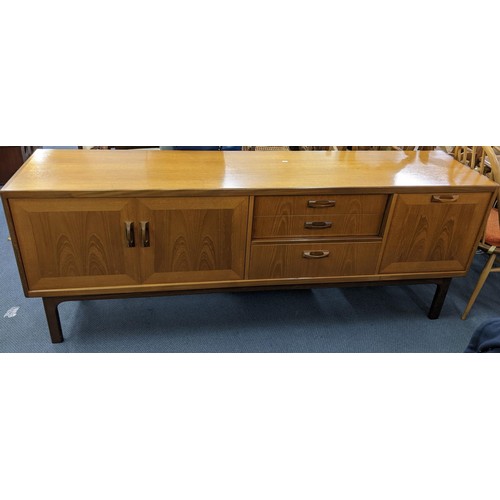 11 - A mid 20th century retro G-Plan teak sideboard having two cupboard doors, three drawers and a pull-d... 