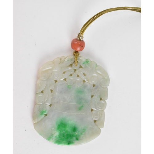 105 - A Chinese carved jade pendant in the form of a bell or archaic vessel with pierced foliage detail, o... 