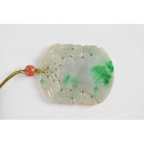 105 - A Chinese carved jade pendant in the form of a bell or archaic vessel with pierced foliage detail, o... 