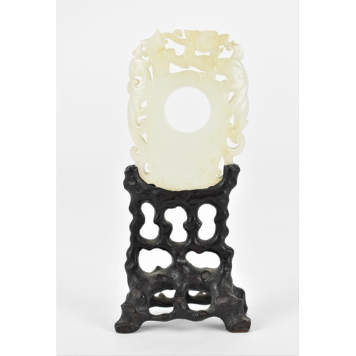 111 - A Chinese carved and pierced white jade plaque on stand, designed with mythical creature and phoenix... 